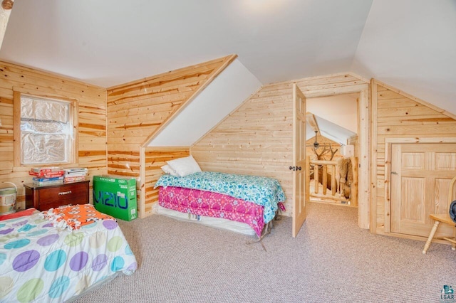 carpeted bedroom with lofted ceiling and wooden walls