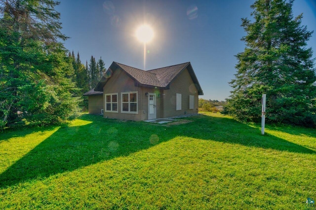 view of side of home featuring a yard