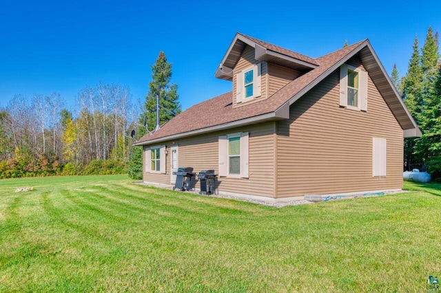 rear view of property featuring a yard