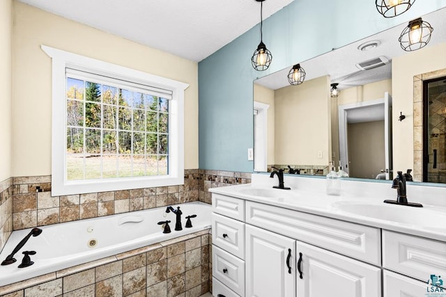 bathroom with vanity and independent shower and bath