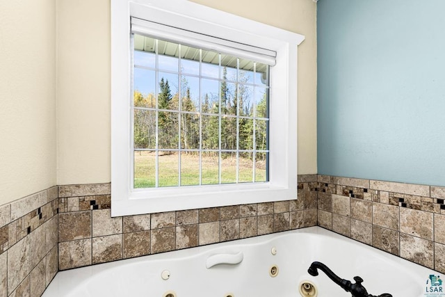 bathroom with a tub to relax in