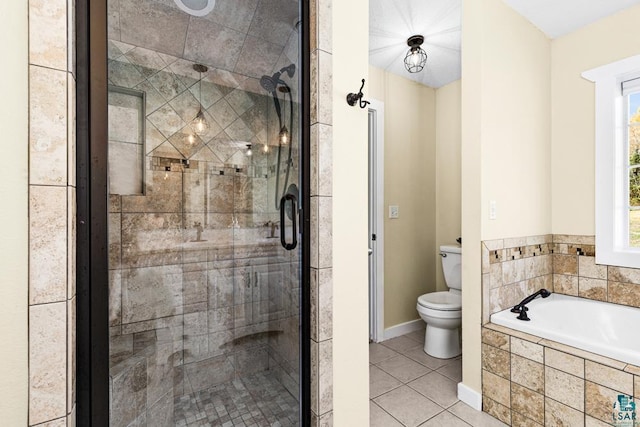 bathroom with a wealth of natural light, tile patterned flooring, independent shower and bath, and toilet