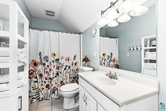 bathroom with tile patterned floors, vanity, a textured ceiling, toilet, and lofted ceiling