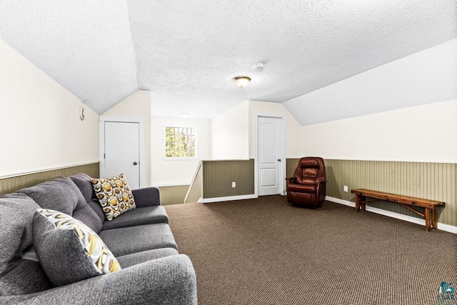 carpeted living room featuring a textured ceiling and vaulted ceiling