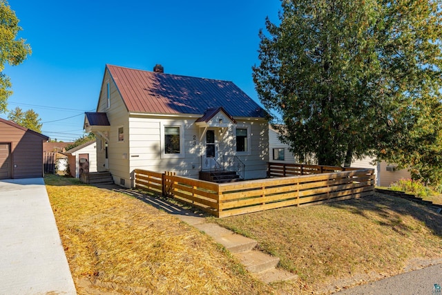 bungalow-style home with a front yard