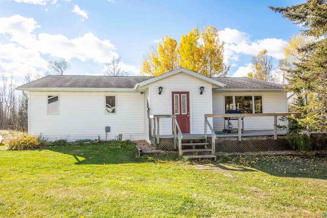 rear view of property with a yard and a deck