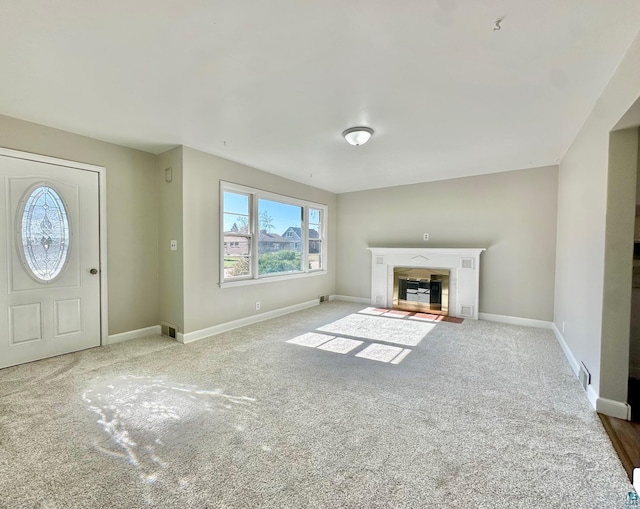 unfurnished living room with carpet floors