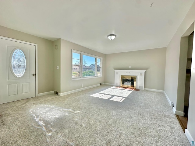 unfurnished living room featuring light carpet and a fireplace