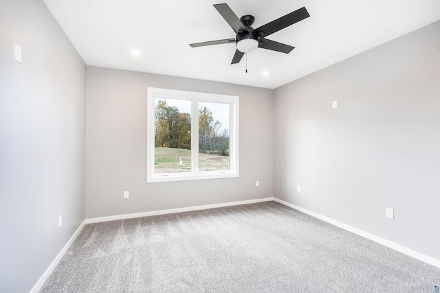 unfurnished room featuring ceiling fan and carpet floors