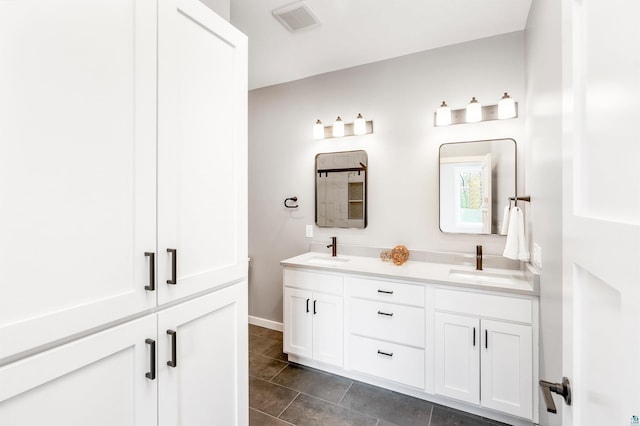 bathroom featuring tile patterned flooring and vanity