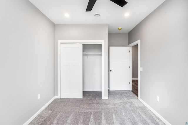 unfurnished bedroom featuring a closet, carpet flooring, and ceiling fan