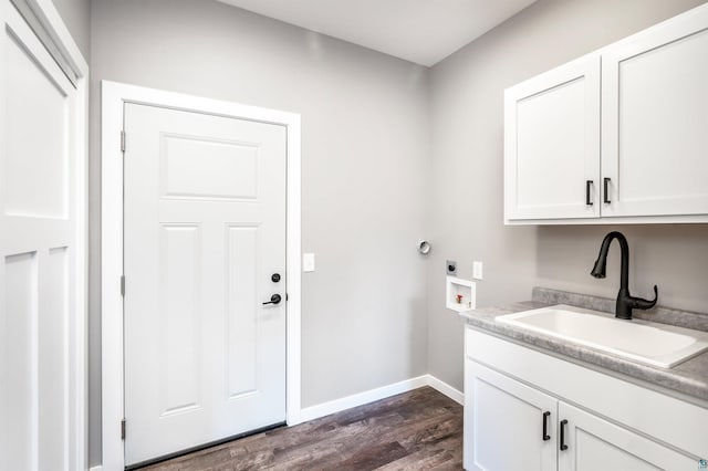 laundry room with cabinets, hookup for an electric dryer, hookup for a washing machine, sink, and dark hardwood / wood-style floors