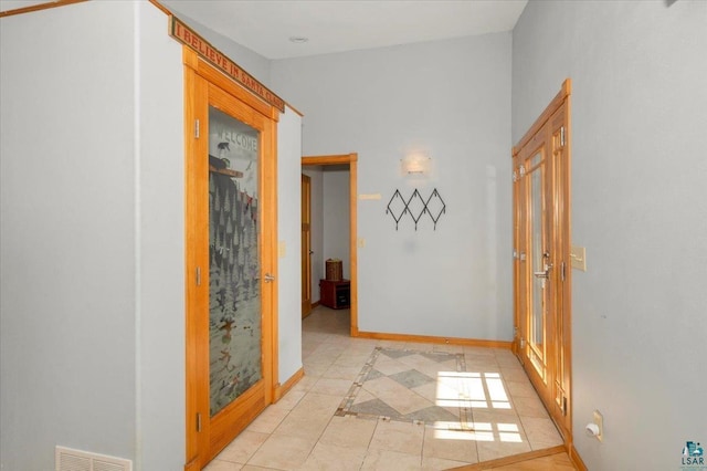 hallway featuring light tile patterned floors