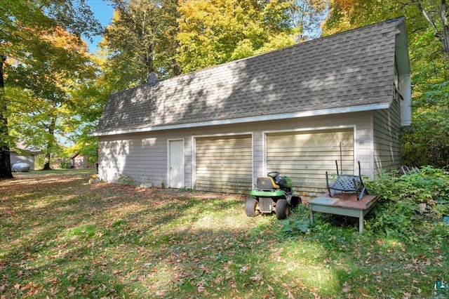 view of outdoor structure featuring a lawn