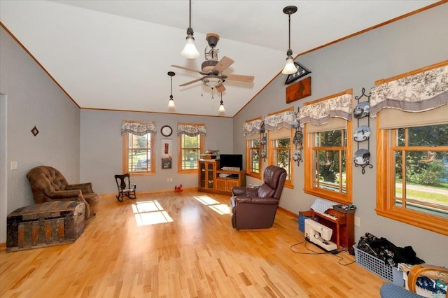 living area featuring light hardwood / wood-style floors, vaulted ceiling, plenty of natural light, and ceiling fan