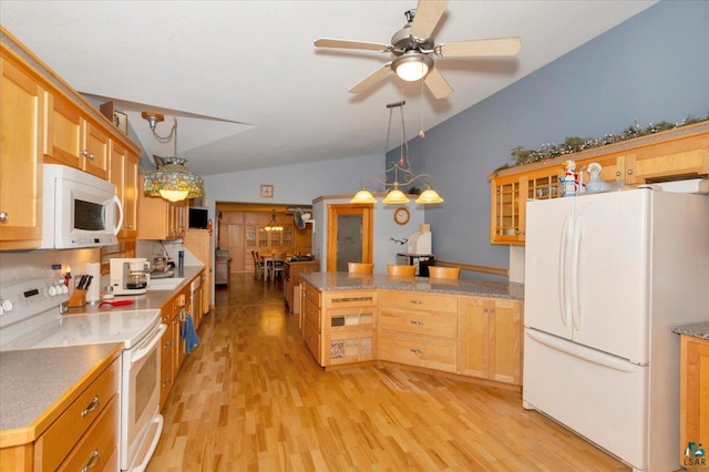 kitchen with vaulted ceiling, light hardwood / wood-style floors, pendant lighting, and white appliances