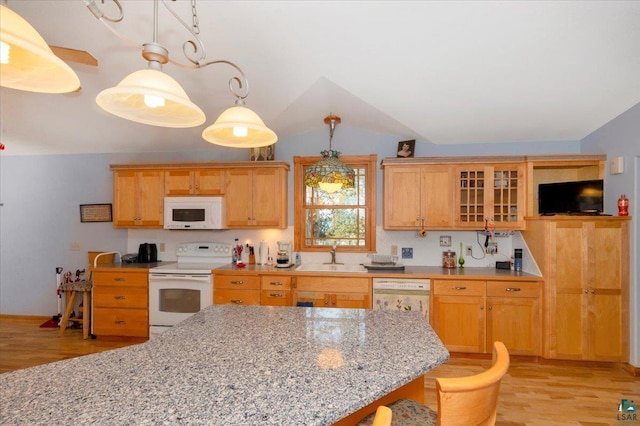 kitchen with vaulted ceiling, light hardwood / wood-style flooring, hanging light fixtures, and white appliances