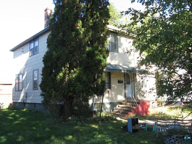 21 White St, Ely, MN 55731 - view of front of home with a front yard and a chimney