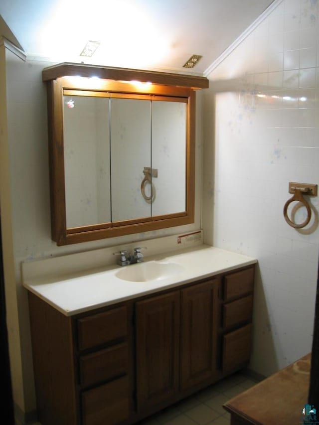 21 White St, Ely, MN 55731 - bathroom featuring vanity, lofted ceiling, and crown molding