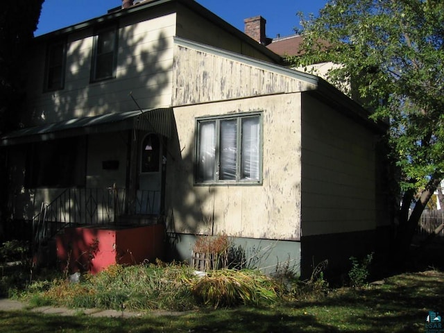 21 White St, Ely, MN 55731 - view of side of property with a chimney
