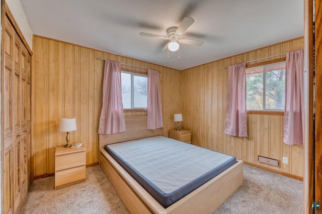 carpeted bedroom with a closet, ceiling fan, and multiple windows