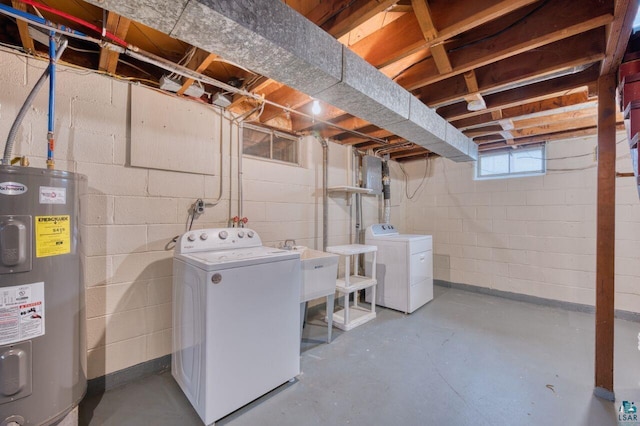 basement with sink, electric water heater, and independent washer and dryer