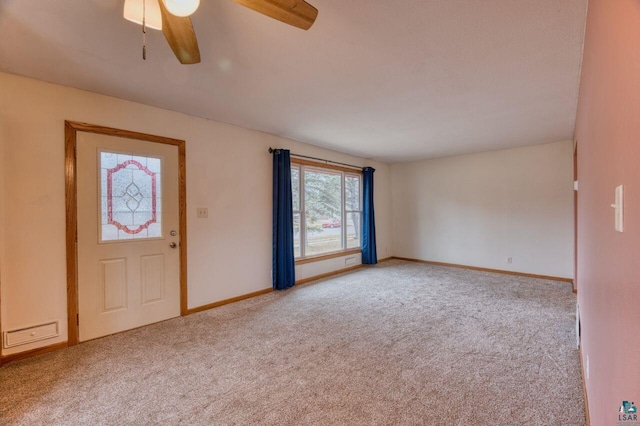 foyer featuring light colored carpet and ceiling fan