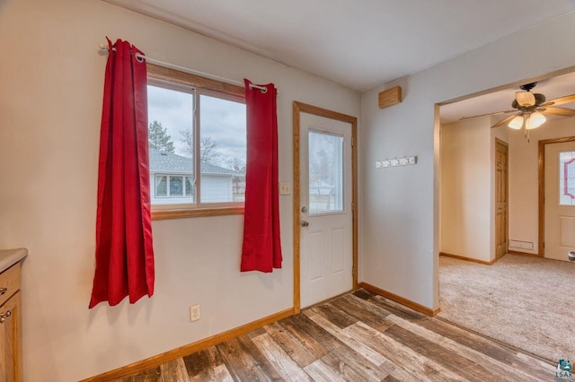 foyer entrance with hardwood / wood-style floors and ceiling fan