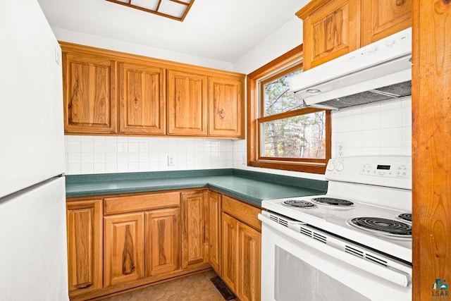 kitchen with white appliances, tasteful backsplash, and ventilation hood