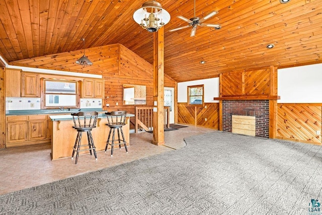 kitchen with wood ceiling, a kitchen bar, a center island, and plenty of natural light