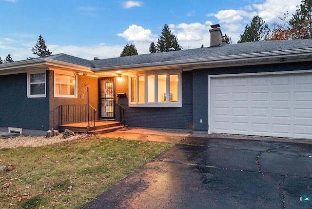 ranch-style home with a front yard and a garage