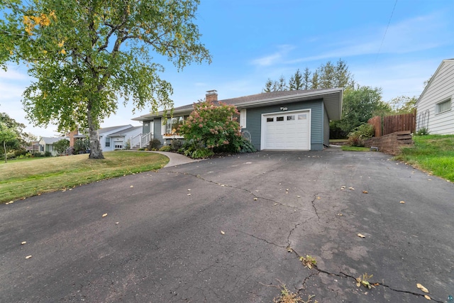 ranch-style house with a front lawn and a garage