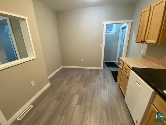 kitchen with dark wood-type flooring and butcher block counters