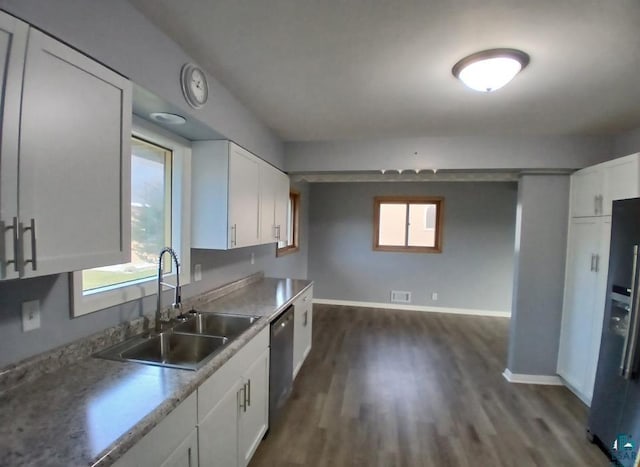 kitchen featuring white cabinets, dishwasher, sink, and dark hardwood / wood-style flooring