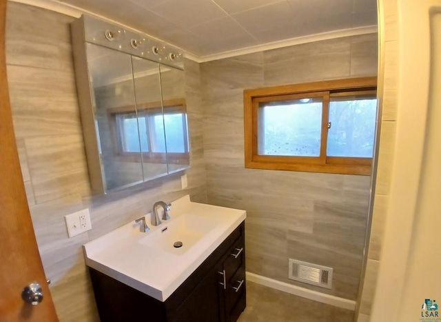 bathroom with vanity and tile walls