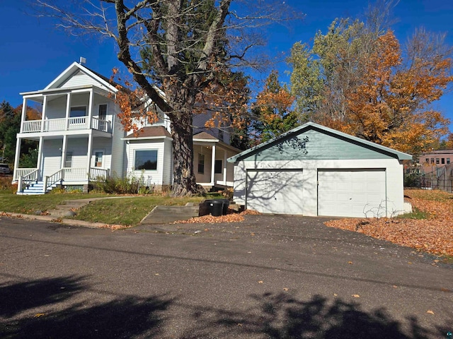 view of front of home featuring a garage and a balcony