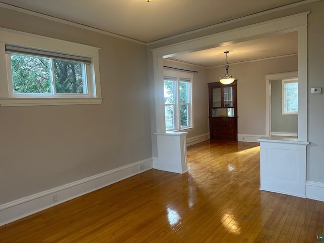 unfurnished room featuring ornamental molding and hardwood / wood-style floors