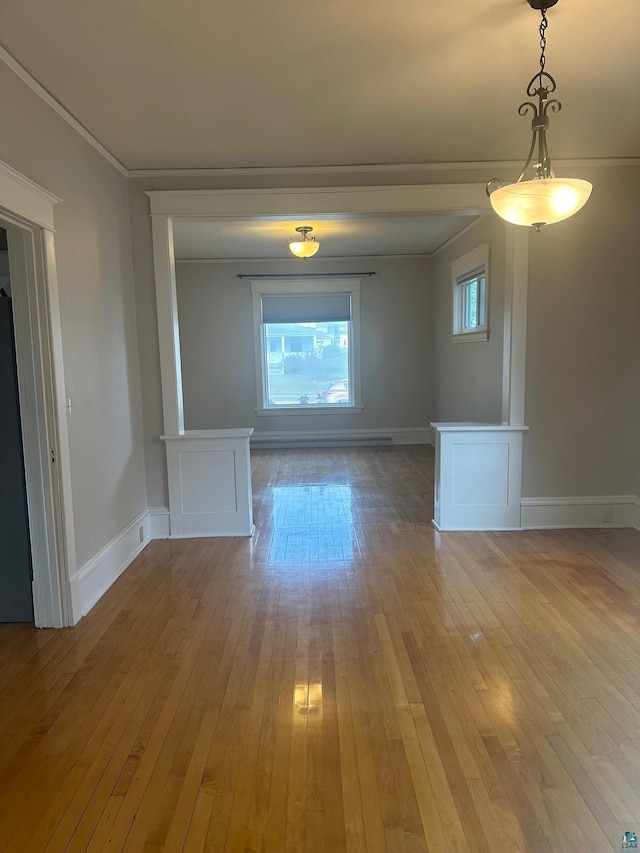 unfurnished room with light hardwood / wood-style floors and crown molding