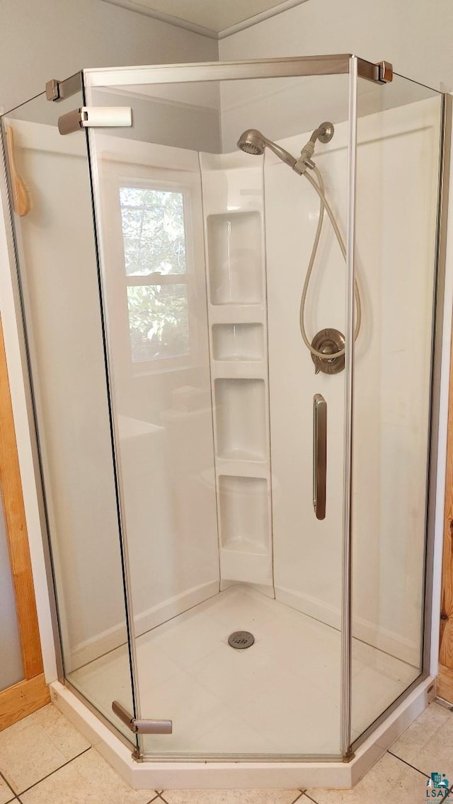 bathroom featuring tile patterned floors and a shower with shower door