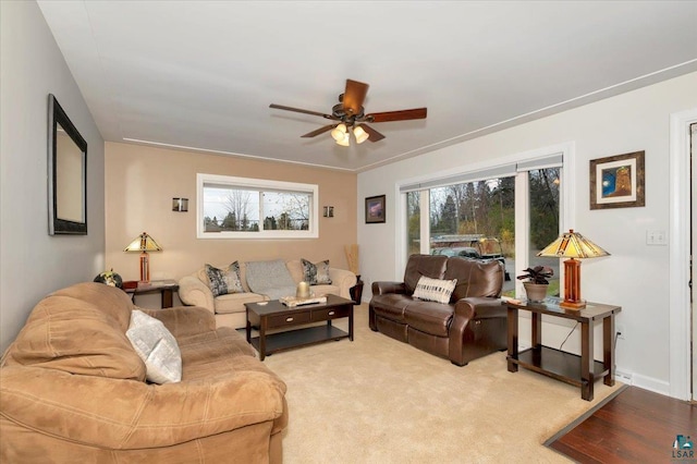 carpeted living room with ceiling fan