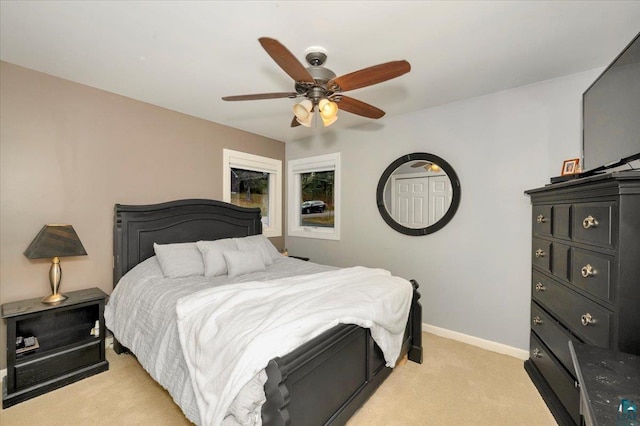 bedroom with ceiling fan and light colored carpet