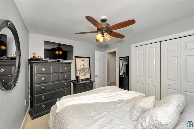 bedroom featuring a closet, light carpet, and ceiling fan