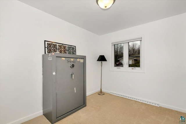 interior space featuring light colored carpet and a baseboard radiator