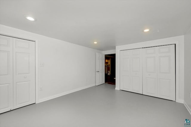 unfurnished bedroom with concrete floors