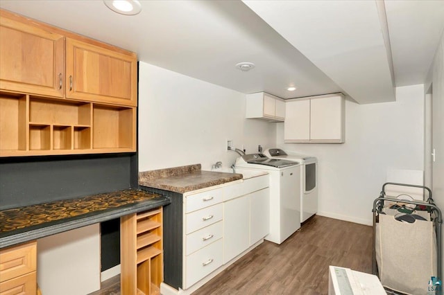 laundry area with cabinets, washer and dryer, and hardwood / wood-style floors