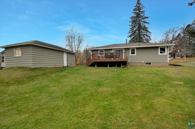 rear view of property with a lawn and a wooden deck