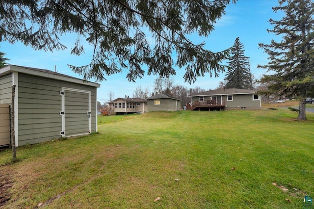 view of yard with a shed and a wooden deck