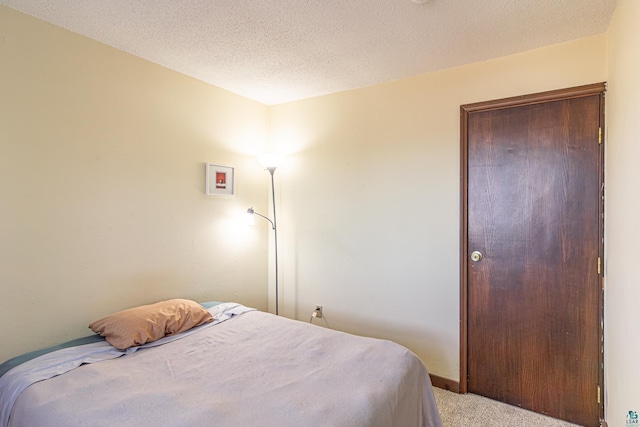 carpeted bedroom with a textured ceiling