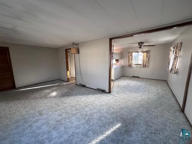 empty room featuring ceiling fan and carpet floors