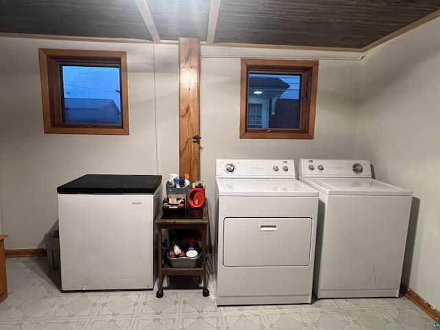 clothes washing area with wood ceiling and independent washer and dryer